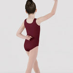 Dancer in a burgundy leotard posing against a white background