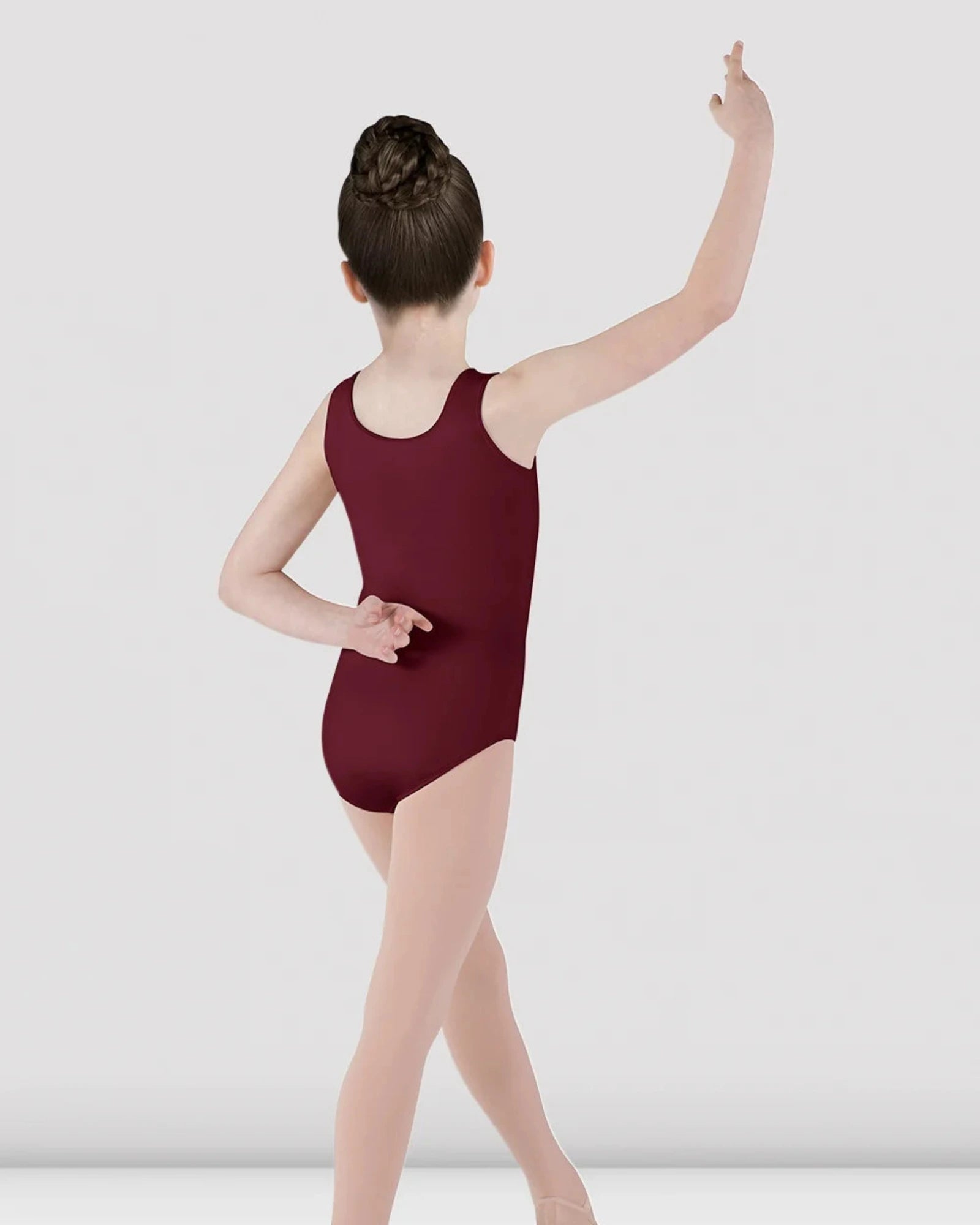 Dancer in a burgundy leotard posing against a white background