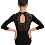 Ballerina wearing a black leotard with a flower print embroidered design on a white background