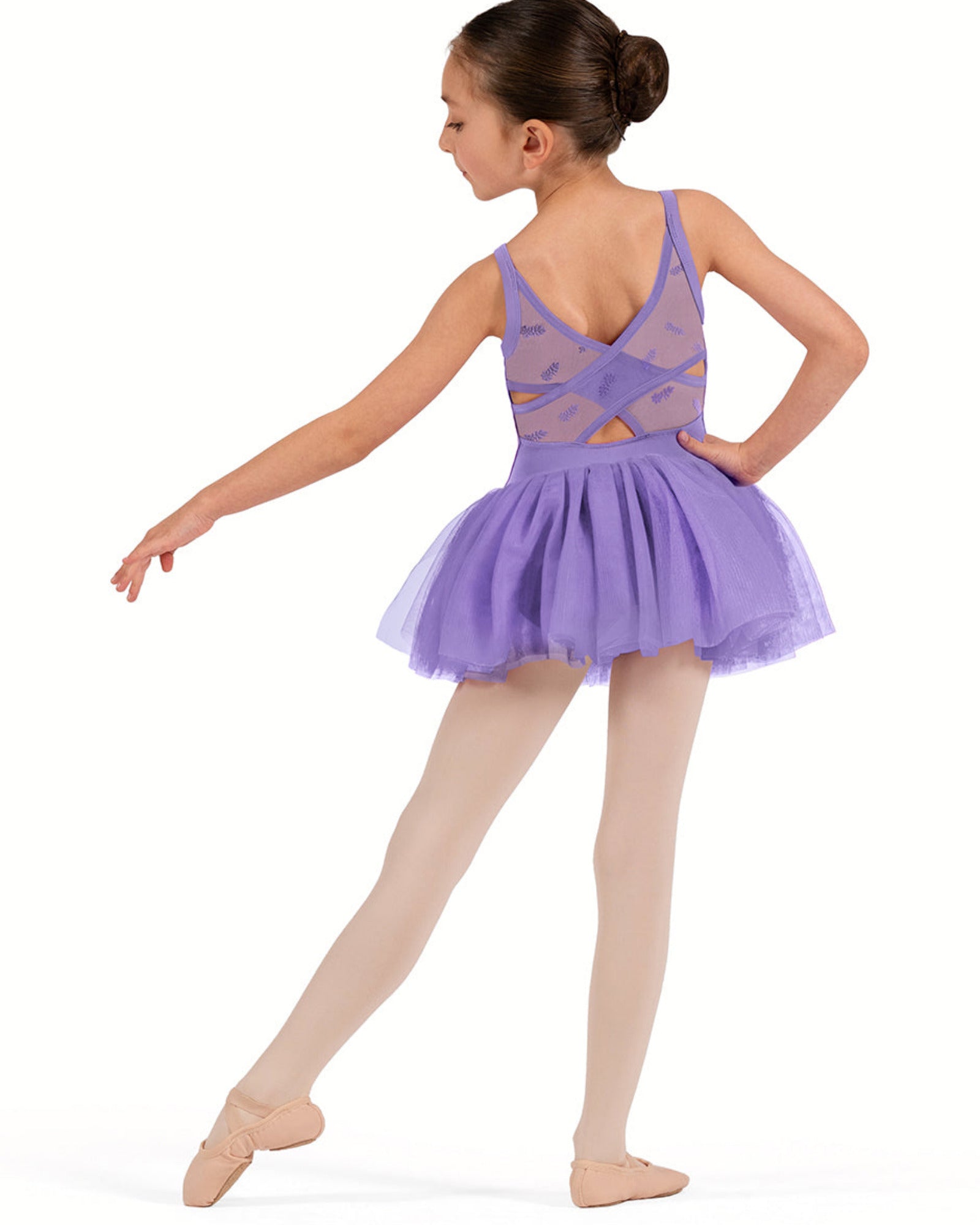 Young girl in a purple ballet dress on a white background