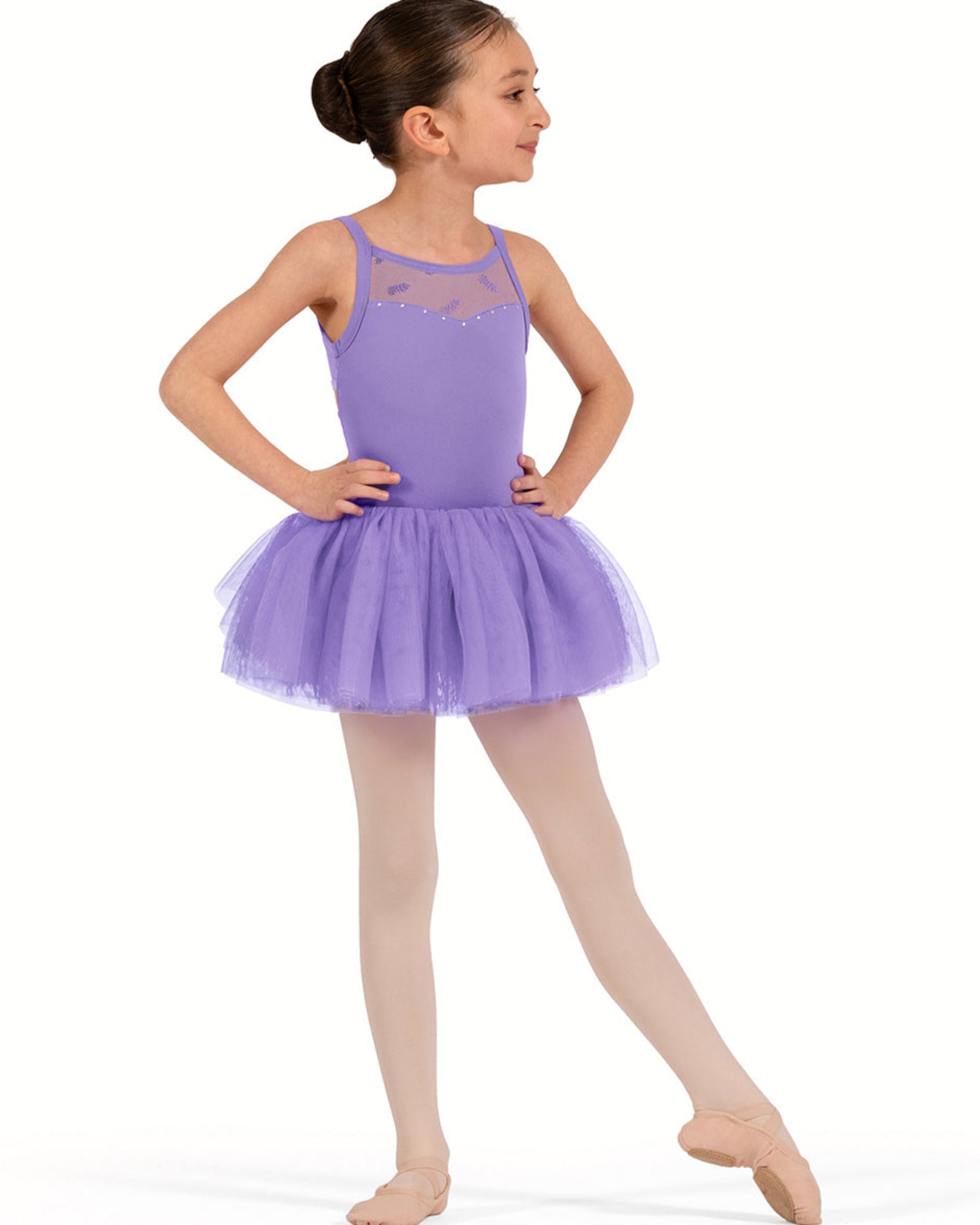 Young girl in a purple ballet dress on a white background