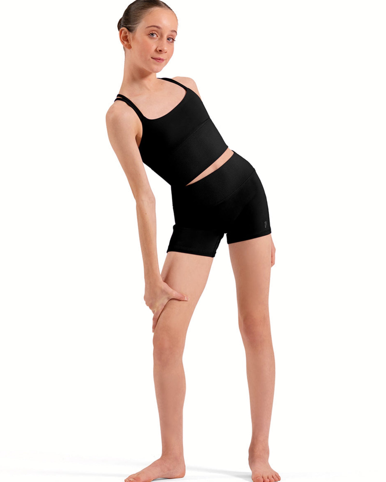 Person wearing a black tank top and shorts on a white background