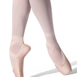Ballet dancer wearing pink tights and pointe shoes on a white background