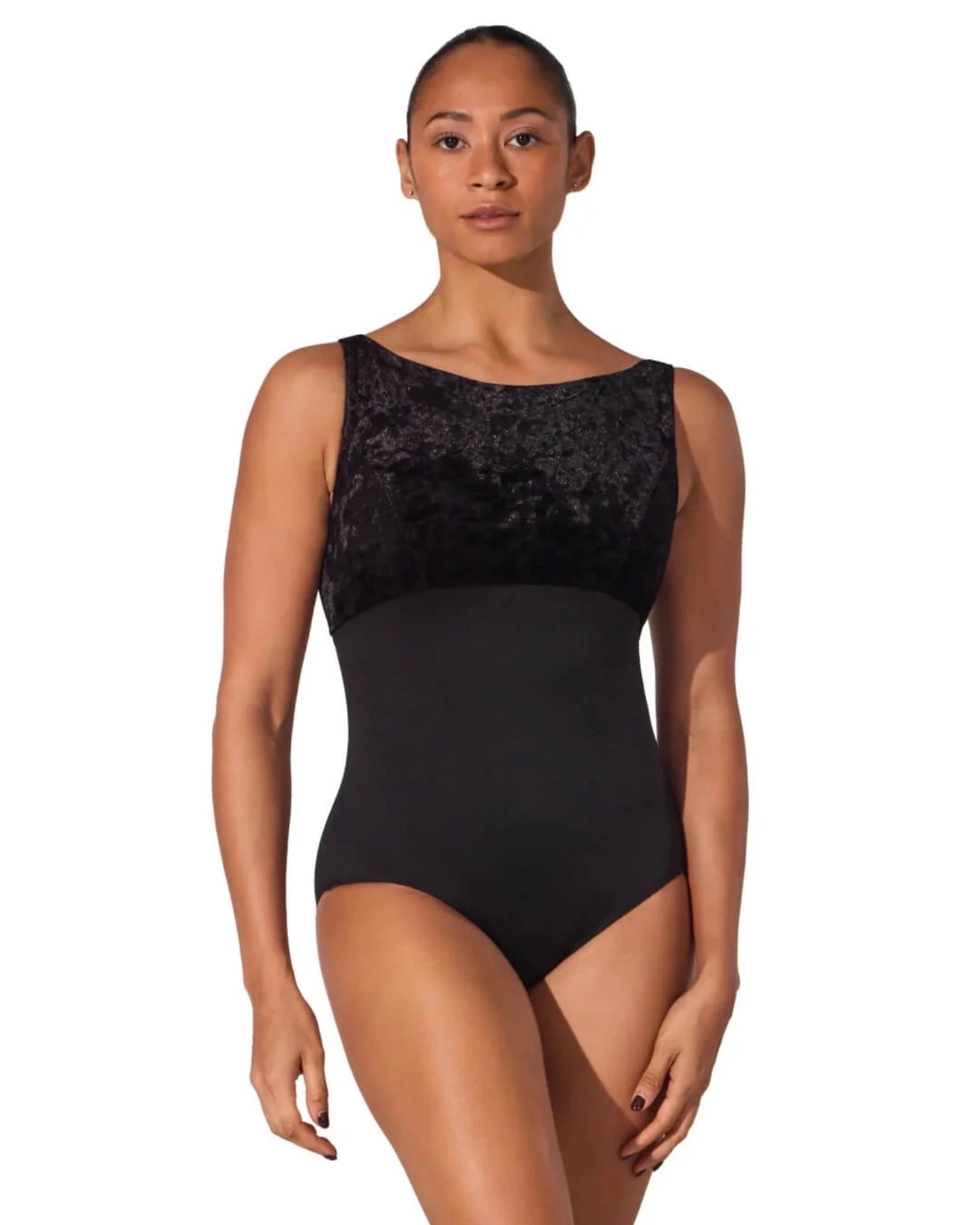 Woman wearing a black leotard with a textured top on a white background