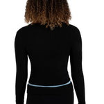 A woman shown from the back wearing a black ribbed long-sleeve top and black pants against a plain white background.