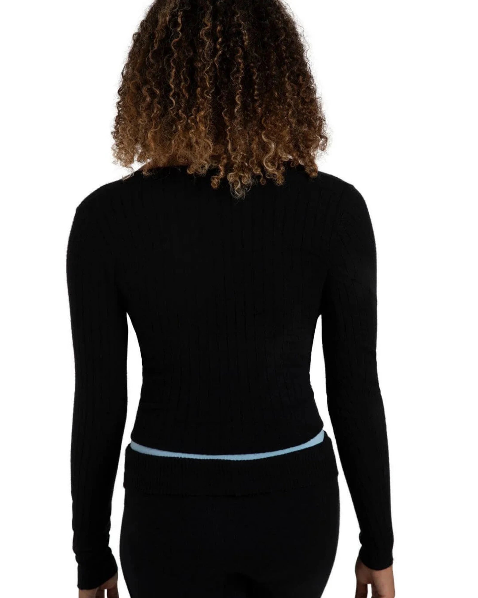 A woman shown from the back wearing a black ribbed long-sleeve top and black pants against a plain white background.