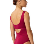 Woman wearing a berry leotard with cut-out design on a white background