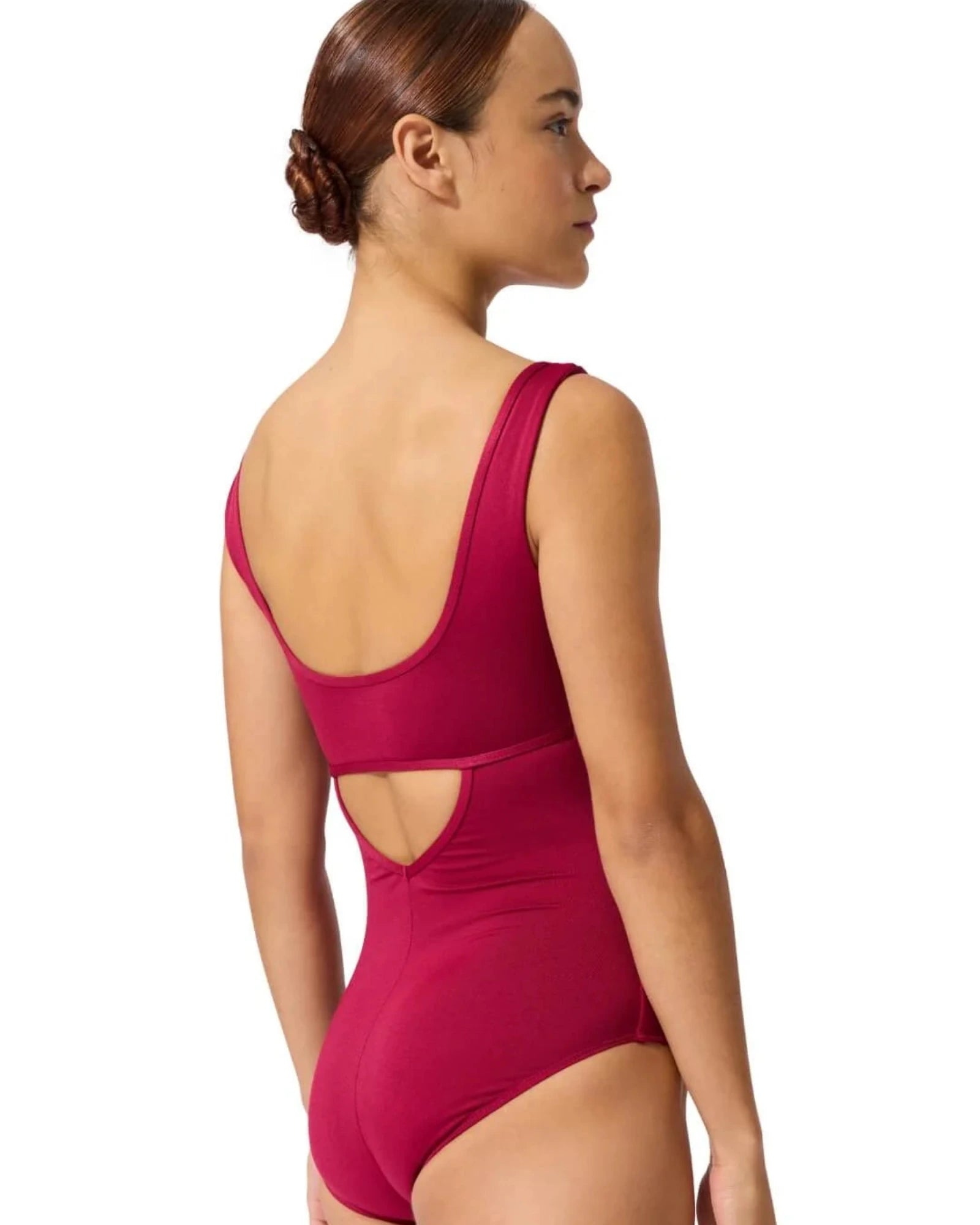 Woman wearing a berry leotard with cut-out design on a white background