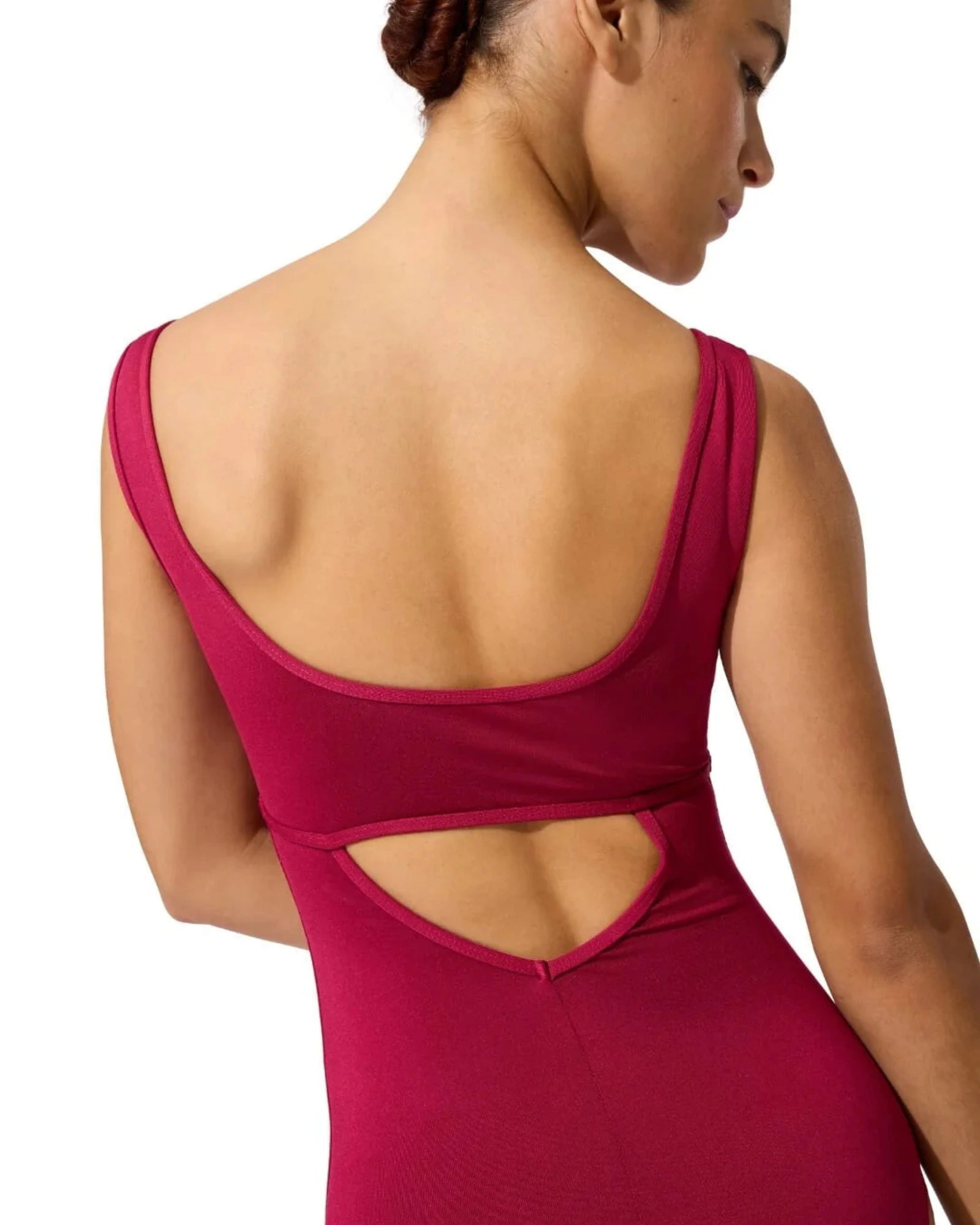A woman shown from the back wearing a sleeveless berry leotard with a wide open back and a cutout detail at the waist, photographed against a plain white background.