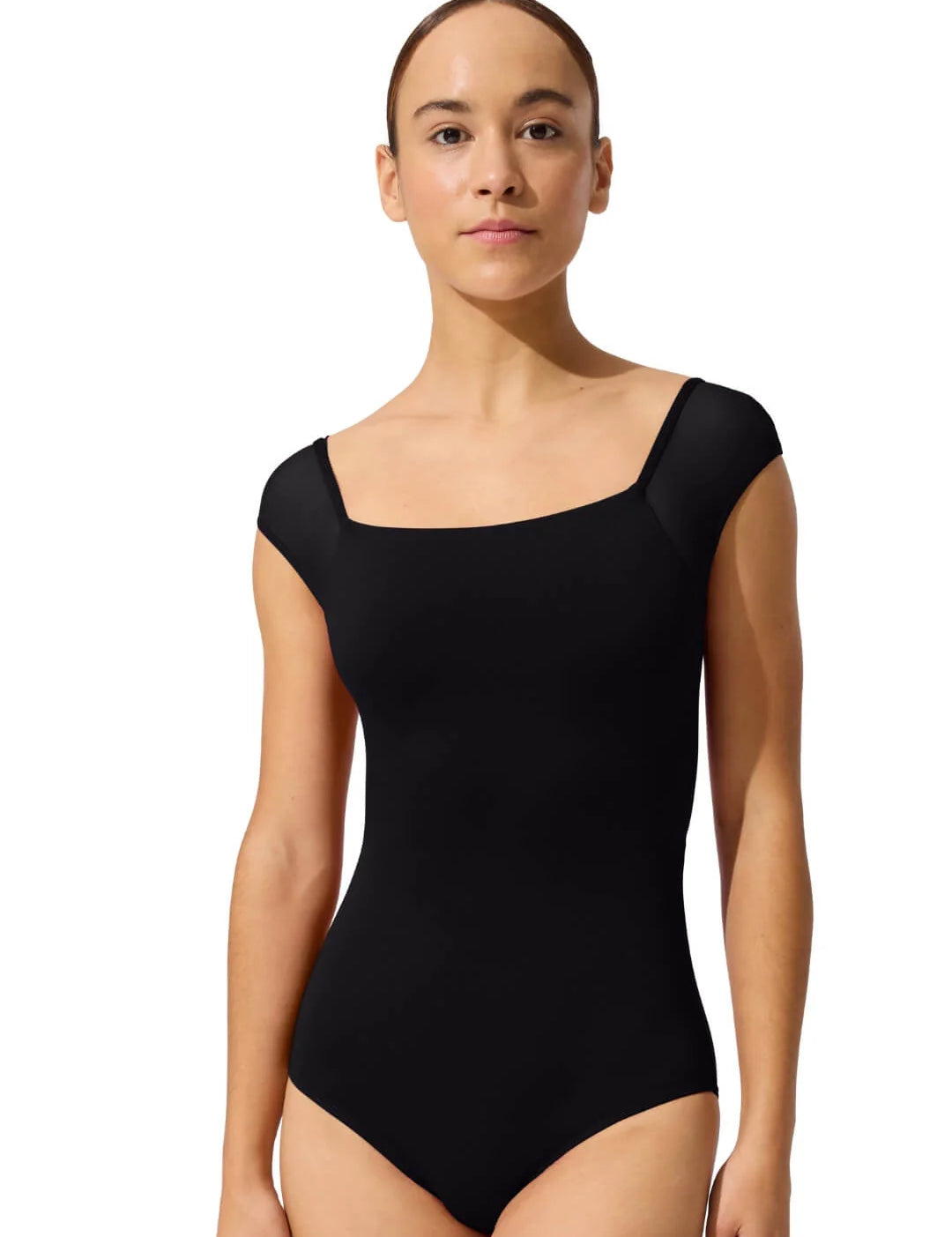 Woman wearing a black leotard on a white background