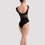 Dancer in a black leotard and ballet shoes on a white background