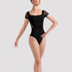 Ballerina in a black leotard on a white background