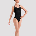 Ballerina in a black leotard and pink ballet shoes on a white background