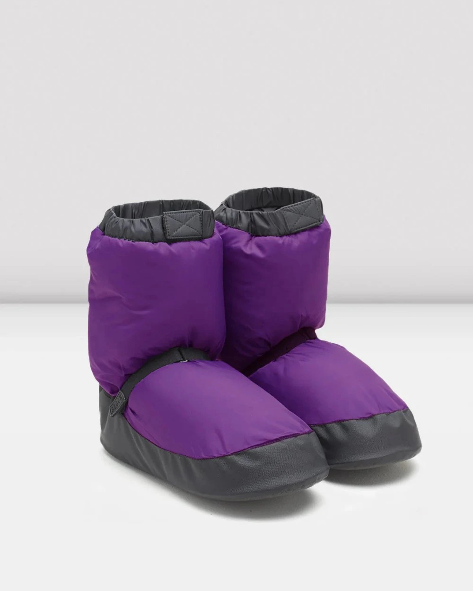 Purple and black booties on a white background