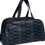 A black duffel bag with a repeating 'DANCE' text pattern in gray, featuring dual top handles and a small black logo patch on the front, set against a plain white background.