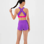 Person wearing a purple bra top and shorts set on a white background