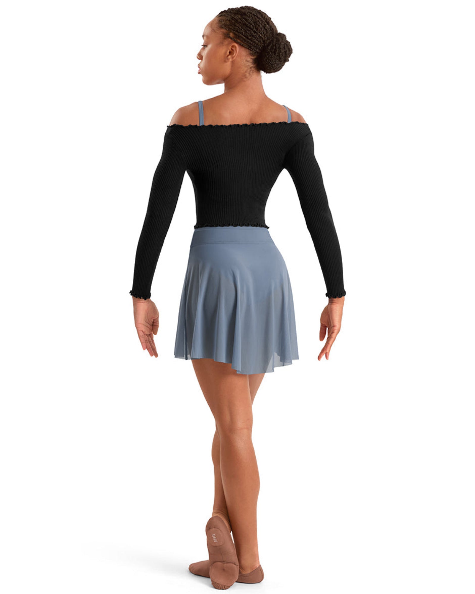 Dancer wearing a black top and blue skirt on a white background