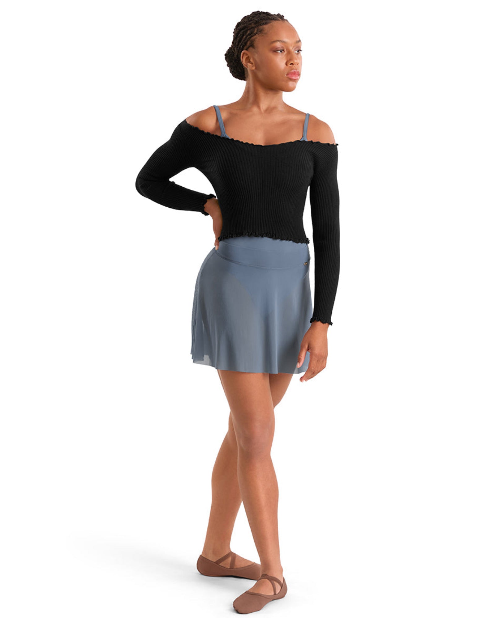 Woman wearing a black top and blue skirt on a white background