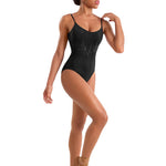Model wearing a black leotard and brown ballet shoes on a white background