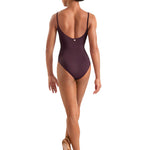 Woman wearing a dark plum leotard on a white background