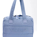 Light blue quilted handbag with 'Nikolay' branding on a white background