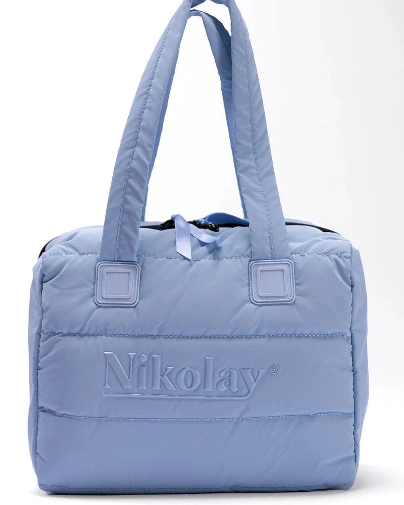 Light blue quilted handbag with 'Nikolay' branding on a white background