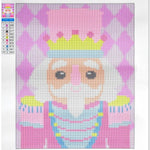 A canvas print of a pixelated cartoon character designed for diamond painting, featuring a pink and purple harlequin pattern background, a yellow crown, and a white beard. The canvas is displayed flat against a white background with a small color reference chart on the left side.