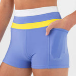 Blue dance shorts with yellow waistband on a white background