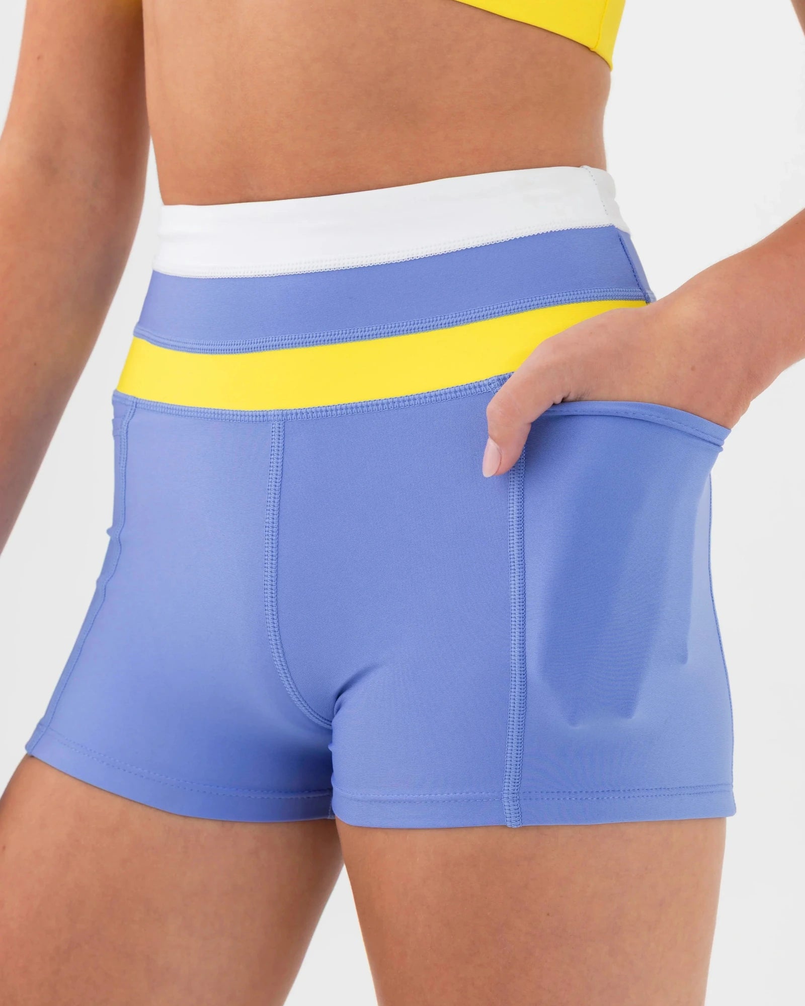 Blue dance shorts with yellow waistband on a white background