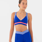 Woman wearing a blue bra top and shorts set on a white background