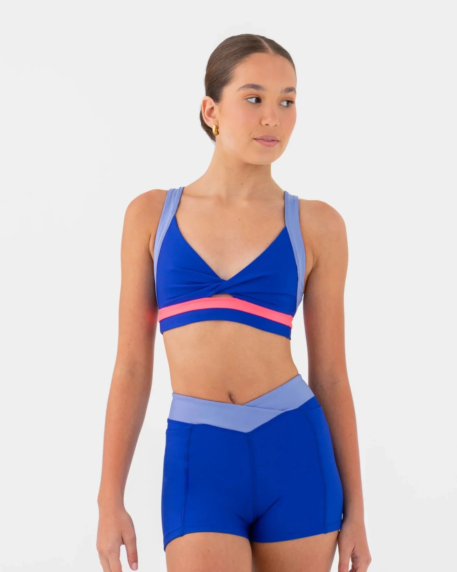Woman wearing a blue bra top and shorts set on a white background