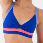 Blue and pink dance bra on a plain background