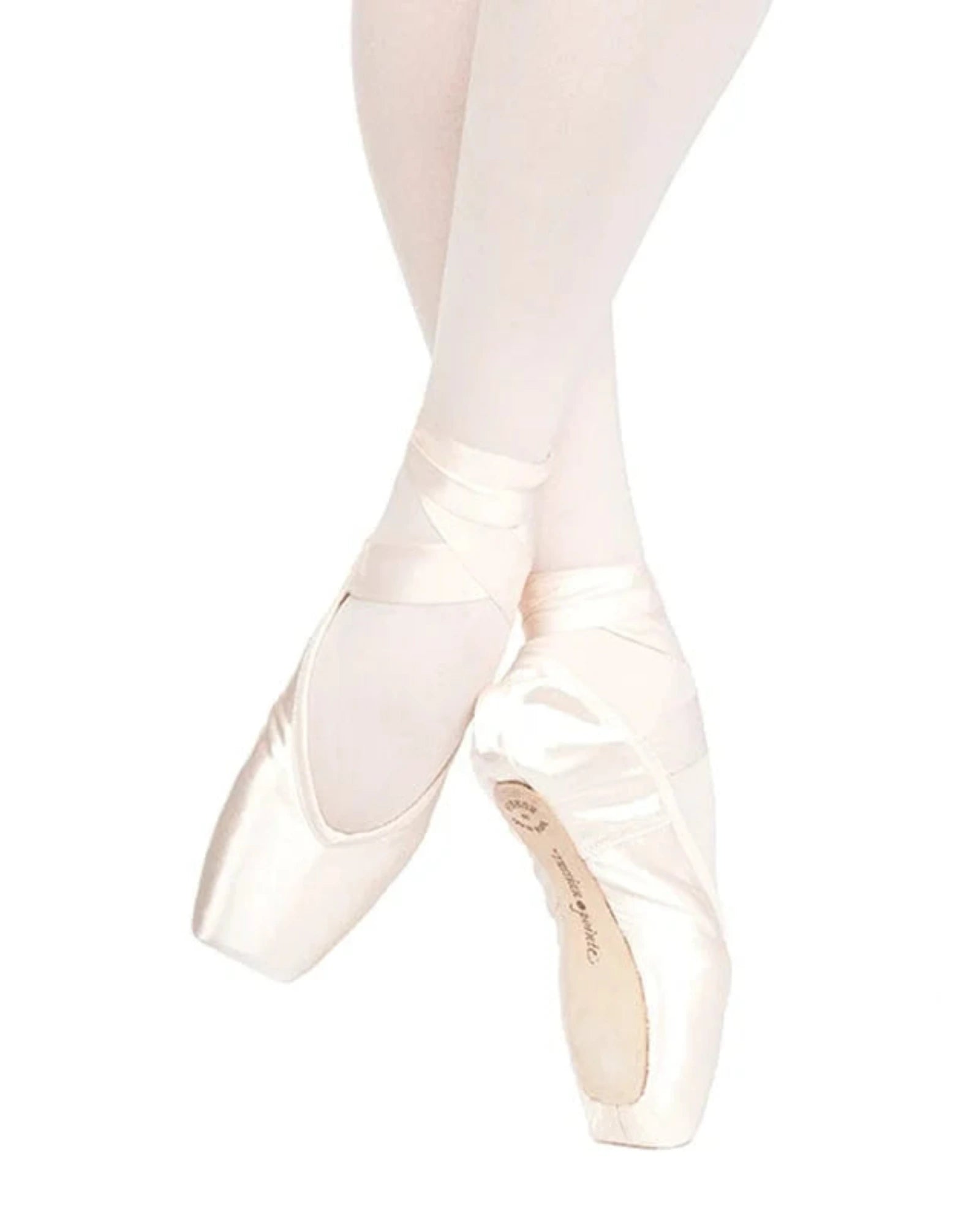A pair of satin pointe shoes worn on a dancer's feet, paired with light pink tights against a solid white background.