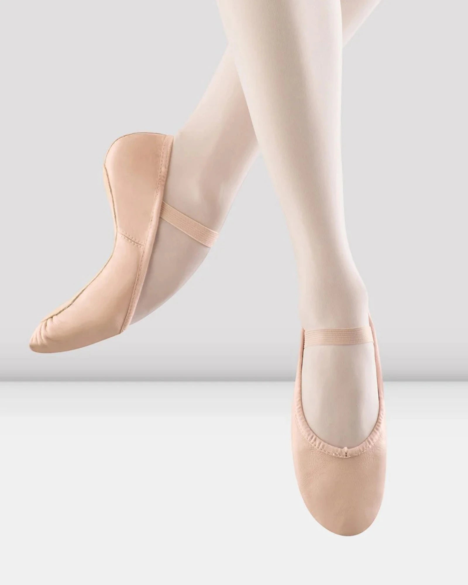 Ballet shoes and tights on a white background