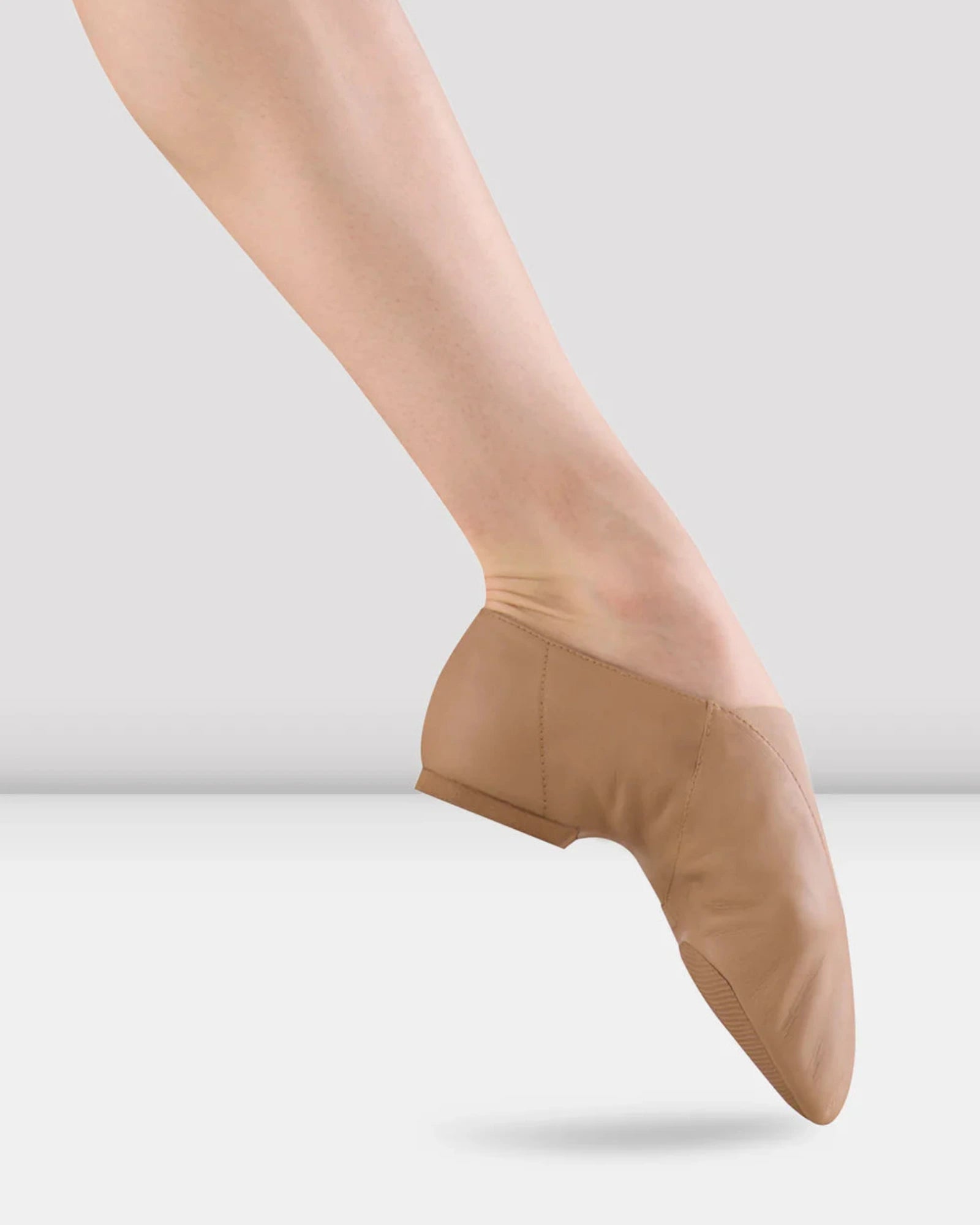 Jazz shoe worn by a dancer on a plain background