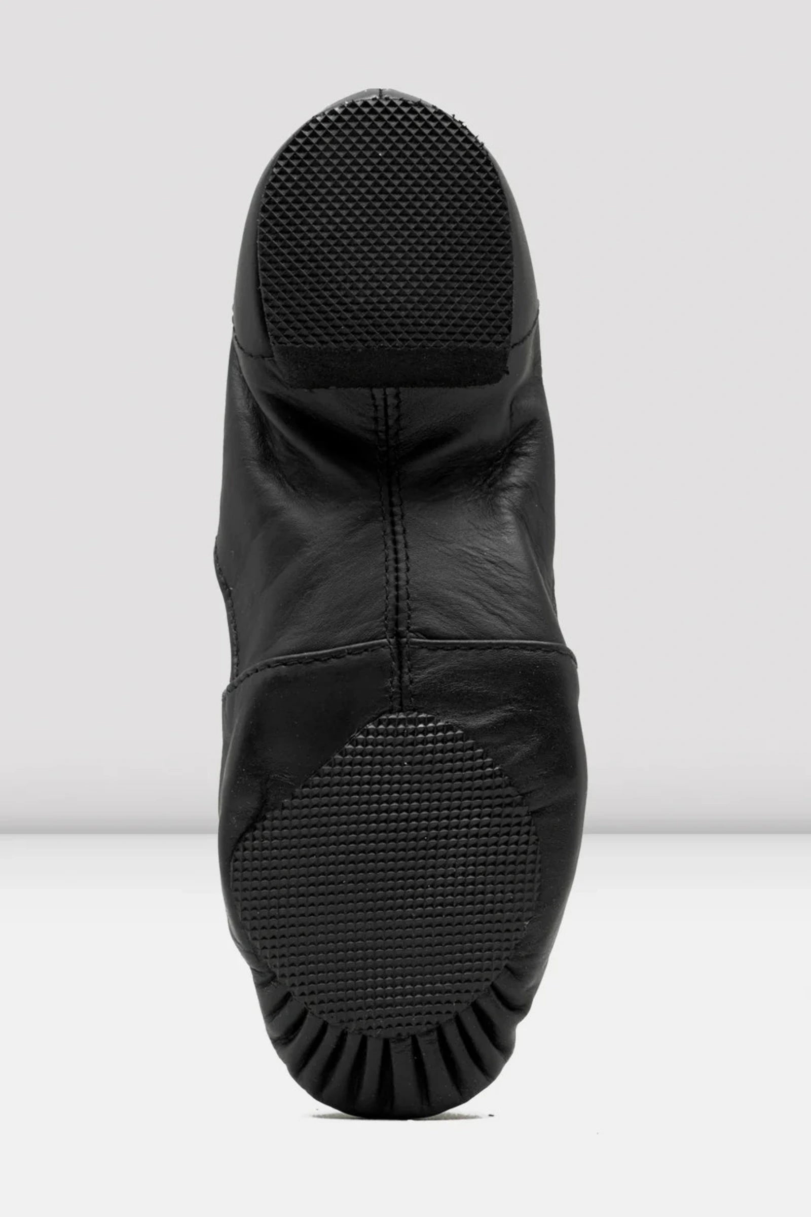 Black dance shoe with sole showing on a white background