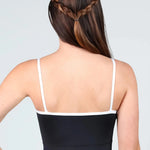 Back view of a woman wearing a black camisole-style leotard with thin white straps and a white band across the upper back, against a light gray studio background.
