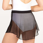 Person wearing a black mesh skirt on a plain background