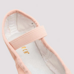 Close-up of a pink ballet shoe on a light gray background