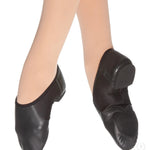 Black jazz shoes worn by a person on a white background