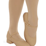 Beige shoes worn with beige tights on a white background