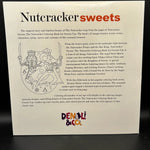 A printed Nutcracker-themed coloring book cover or booklet page shown against a dark background. The page has a white base with black text, red 'sweets' heading, illustrated nutcracker figures, and a visible 'Denali & Co.