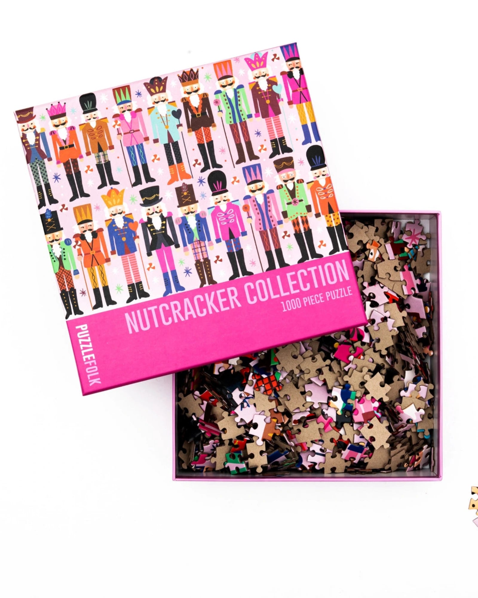 Nutcracker-themed puzzle with pieces scattered outside the box on a white background