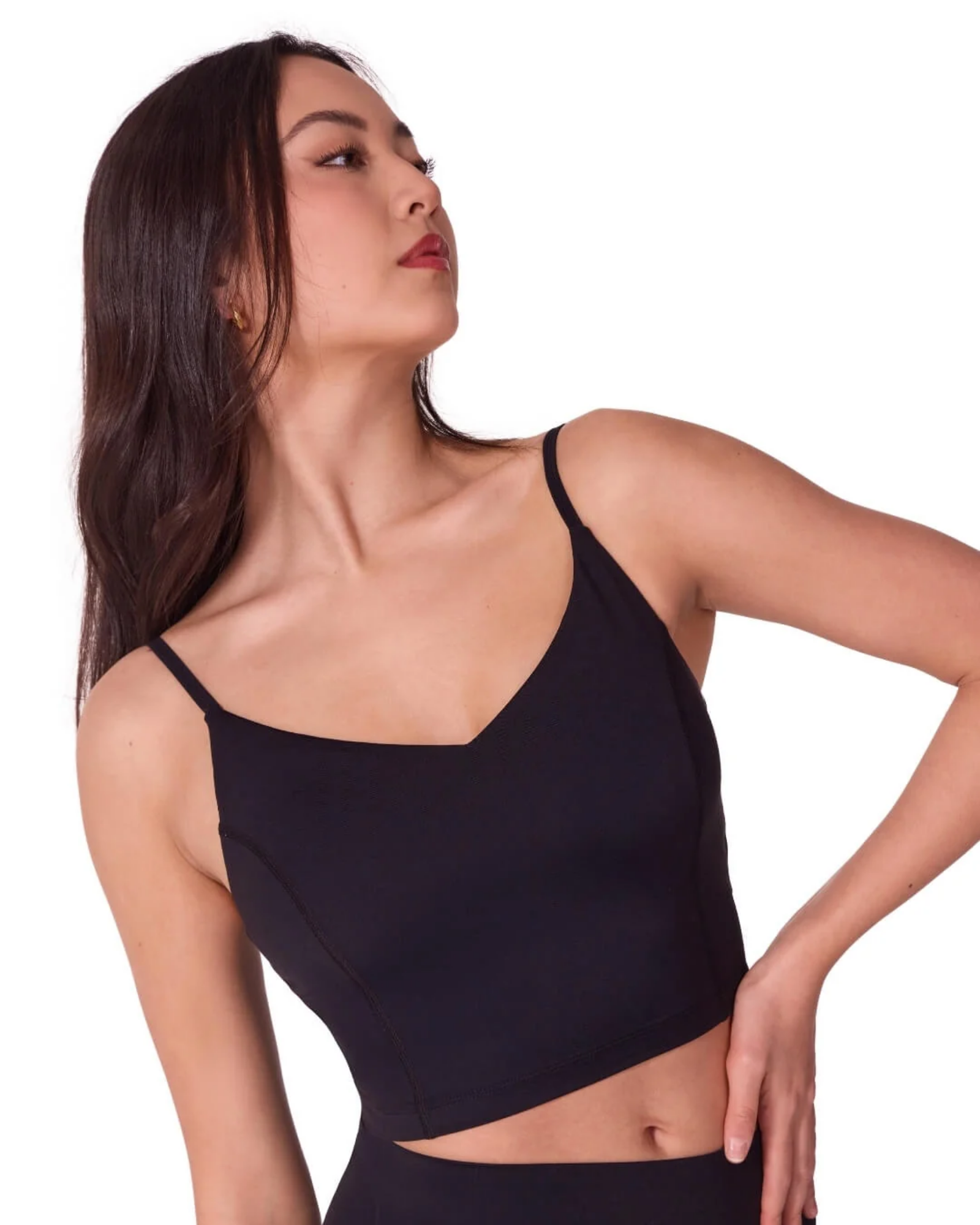 Woman wearing a black tank top against a white background