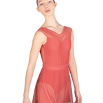 Woman wearing a coral-colored leotard with matching mesh skirt on a white background