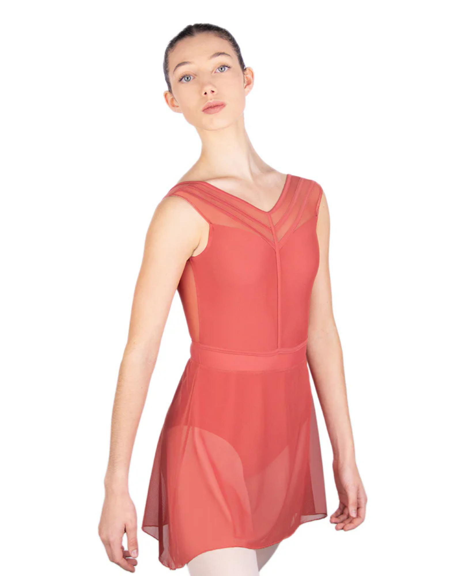 Woman wearing a coral-colored leotard with matching mesh skirt on a white background