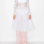 A model wearing a white lace and tulle ballet outfit with long sleeves, a sweetheart bodice, and a full tutu skirt, paired with light pink leggings and metallic pink ballet slippers, against a plain white studio background.