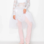 A woman modeling a white lace long-sleeve crop top and a sheer white tutu skirt with light pink tights and ballet pointe shoes, posed against a plain white studio background.