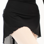 Black skirt with sheer overlay on a white background