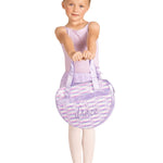 Young girl in ballet attire holding a purple ballet bag with 'dance' on a white background